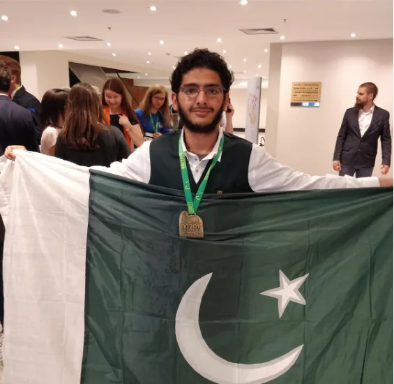 A young Pakistani software developer at a computer, symbolizing the nation's emerging tech talent and the challenge of brain drain